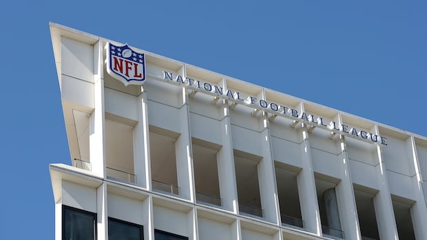 NFL headquarters building with company signage against a clear sky in a business district