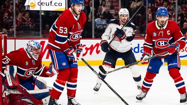 Montreal Canadiens defenseman Noah Dobson blocks a shot and is hit by the puck during a game against Columbus Blue Jackets