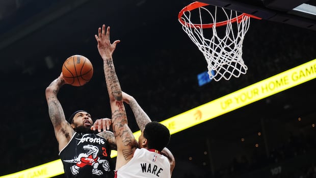 Toronto Raptors' Brandon Ingram attempts dunk over Miami Heat's Kel'el Ware during NBA game in Toronto