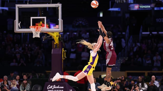 Toronto Tempo player shoots a jump shot over a leaping Los Angeles Sparks defender during the game