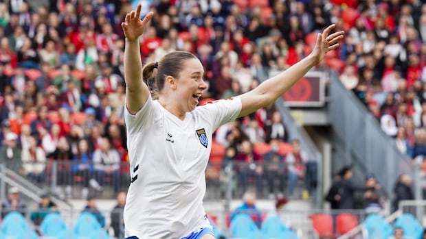 Female soccer player celebrates after scoring a goal during a match between Montreal Roses and Ottawa Rapid