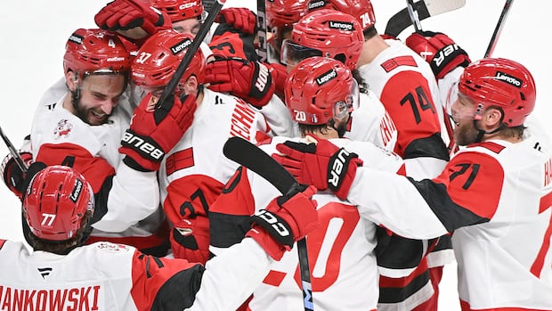 Montreal Canadiens goalie Jakub Dobes blocks a shot from Carolina Hurricanes player Jackson Blake during overtime