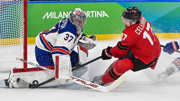 Macklin Celebrini of Canada attempts to score against US goalie Connor Hellebuyck in Olympic men's hockey final
