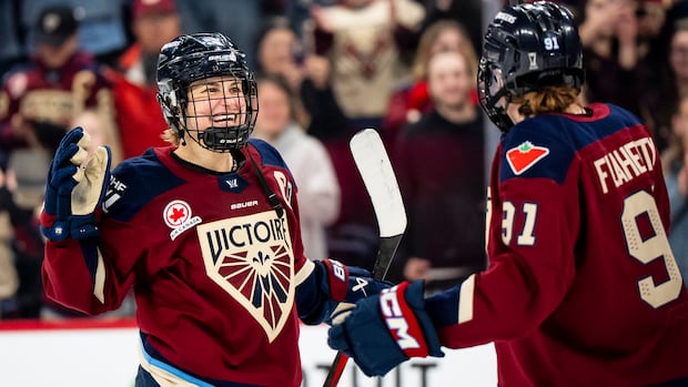 Marie-Philip Poulin celebrates on the ice with her teammate after a crucial win in the Walter Cup tournament
