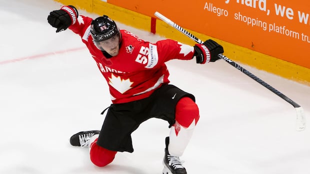 Hockey player celebrating goal during overtime in a crucial game between Canada and an opposing team