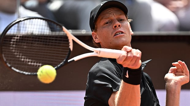 Jannik Sinner in action returning a shot against Andrey Rublev at the Italian Open tennis tournament in Rome
