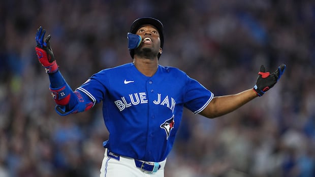 Blue Jays outfielder Jesús Sánchez celebrates with hands up after hitting a grand slam at Rogers Centre