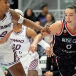 Bridget Carleton driving to the basket closely defended during a WNBA game