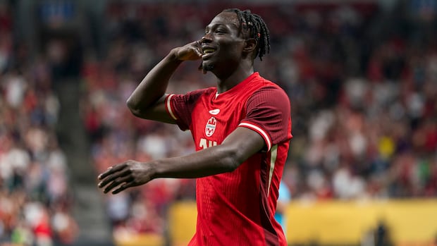 Canadian soccer player Promise David celebrates a goal during a World Cup match