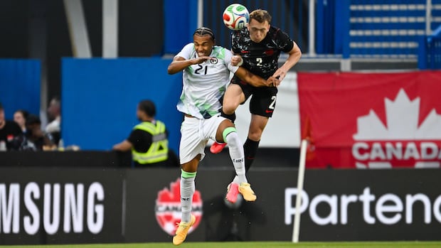 Canadian and Irish players jump to head the ball during a soccer match ahead of the FIFA World Cup