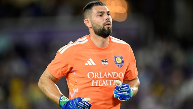 Maxime Crépeau in goal wearing Canada's soccer kit ready to defend during a match