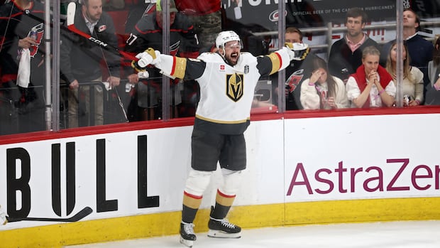 Hockey player Tomas Hertl celebrates with outstretched arms after scoring in Stanley Cup final Game 1 against Hurricanes
