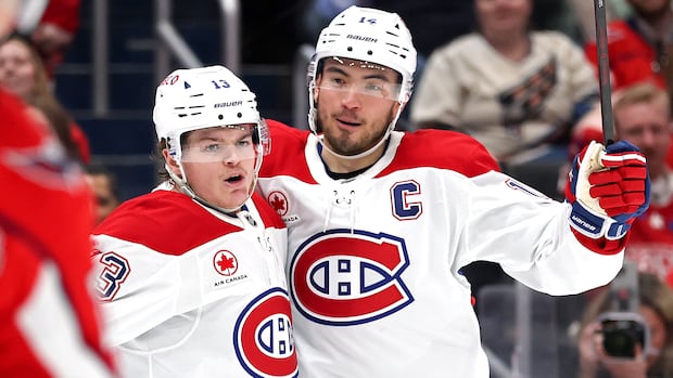 Montreal Canadiens captain Suzuki and teammate Caufield celebrate on ice after winning Selke and Lady Byng trophies