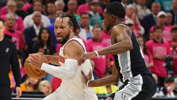 Jalen Brunson driving past defender toward the basket during intense NBA Finals Game 1 between Knicks and Spurs