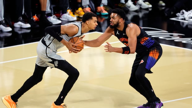 Knicks and Spurs players battle for the ball during an intense NBA Finals game