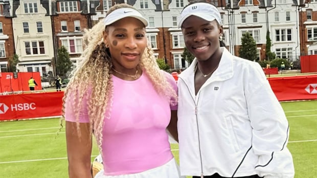 Serena Williams and Victoria Mboko stand side by side on a tennis court posing for a photo during a tennis event