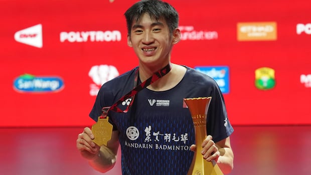 Victor Lai celebrating on the podium after winning men's singles final at POLYTRON Indonesia Open 2026 in Jakarta